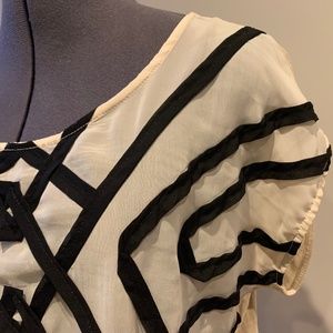 Sheer modern top with geometric detail
